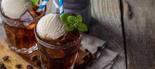 Iced coffee cocktail made with Dancing Moon Coffee, served over ice with a scoop of vanilla ice cream and fresh mint